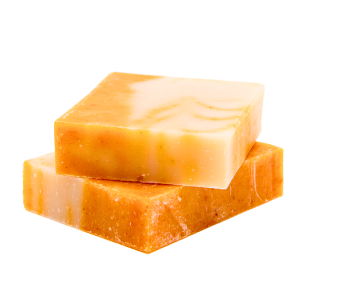 Two bars of soap with a solid, light orange color and a smooth texture, stacked in an overlapping fashion.